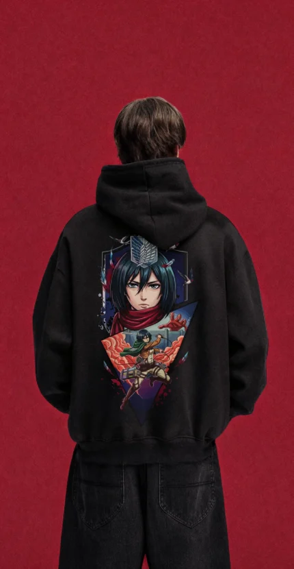 Model wearing a black Attack on Titan hoodie, back view with Mikasa portrait and action collage