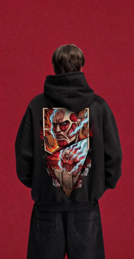 Model wearing a black Attack on Titan hoodie, back view with colourful Colossal Titan collage