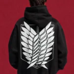Model wearing a black Attack on Titan hoodie, back view with white Scout Regiment wings emblem