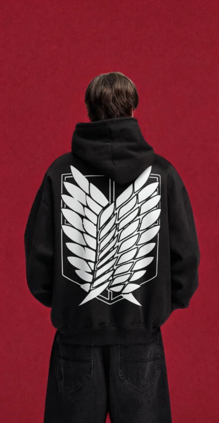 Model wearing a black Attack on Titan hoodie, back view with white Scout Regiment wings emblem
