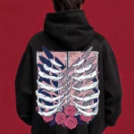 Black Attack on Titan hoodie with ribcage, wings and roses back print, worn by a model
