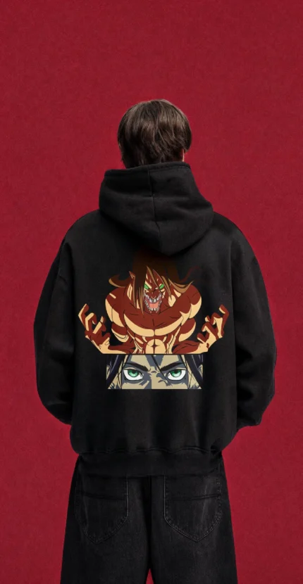 Model wearing a black Eren Attack Titan hoodie, back view with Titan and green-eye graphic
